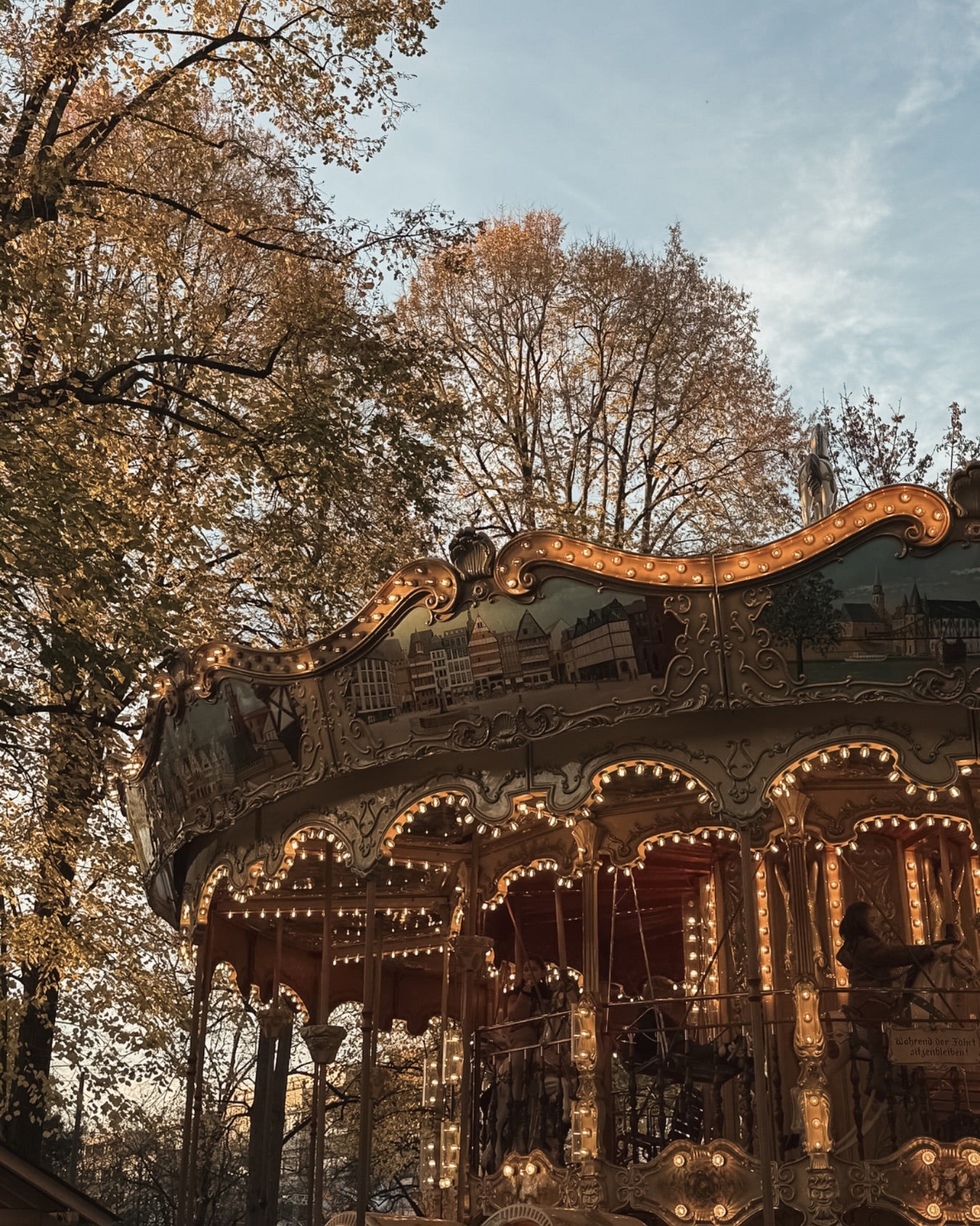 Carousels with lights in a park setting